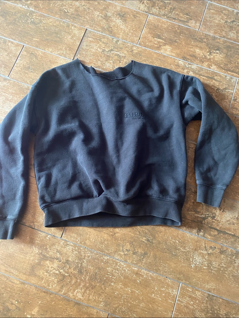 Essentials Black Pullover Sweatshirt with Logo. Size small. Neck has been cut.